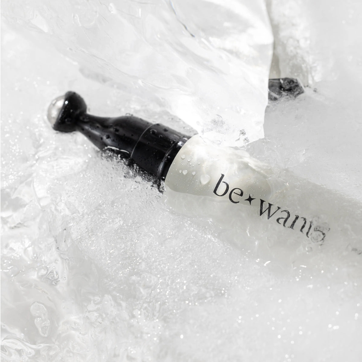 Bewants Phyto Collagen Eye Serum Stick applicator submerged in water close-up