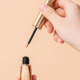 Cosnori Eyelash Serum 100 EX held in hand showing brush applicator