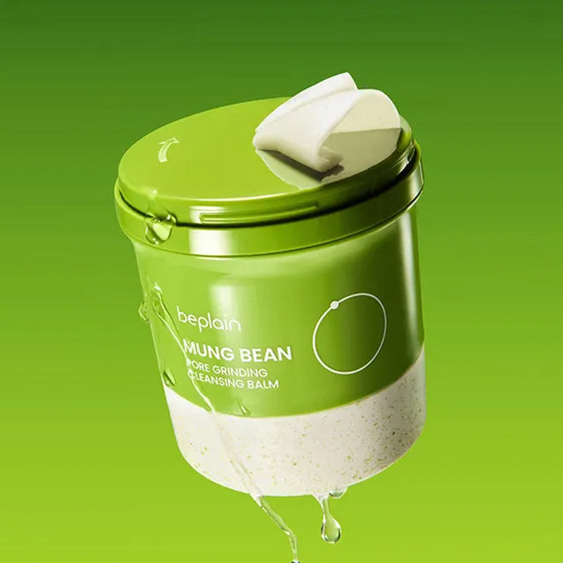 Beplain Mung Bean Pore Grinding Cleansing Balm 100ml with freshly ground mung bean powder texture and water droplets, showing the balm's creamy moistened formula