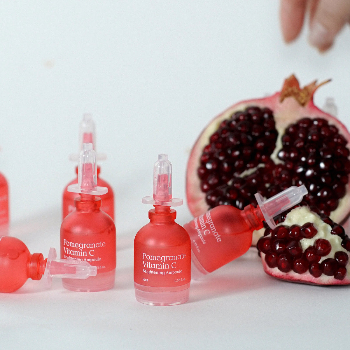 NDP Pomegranate Vitamin C Brightening Ampoule placed in a bright skincare routine setting for glowing skin