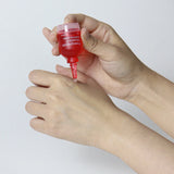 Applying NDP Pomegranate Vitamin C Brightening Ampoule to improve skin radiance and even tone