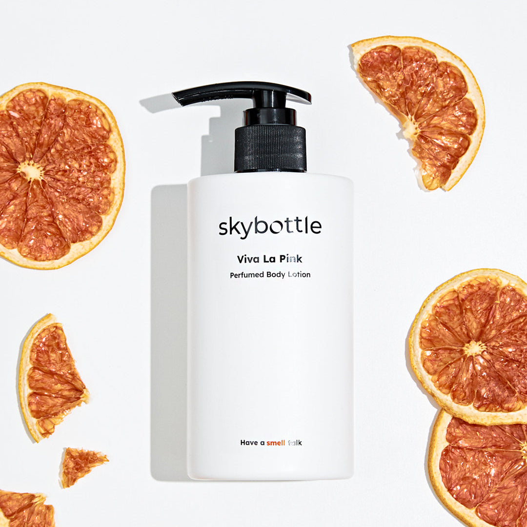 Skybottle Perfumed Body Lotion Viva La Pink 300ml bottle with fresh grapefruit in background