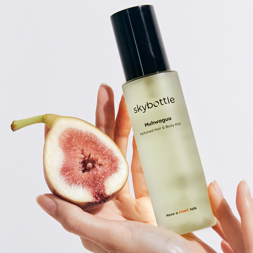 Skybottle Perfumed Hair Body Mist Muhwagua 100ml held in hand with fresh figs
