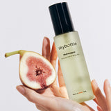 Skybottle Perfumed Hair Body Mist Muhwagua 100ml held in hand with fresh figs